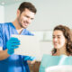 A professional dentist is checking the patient