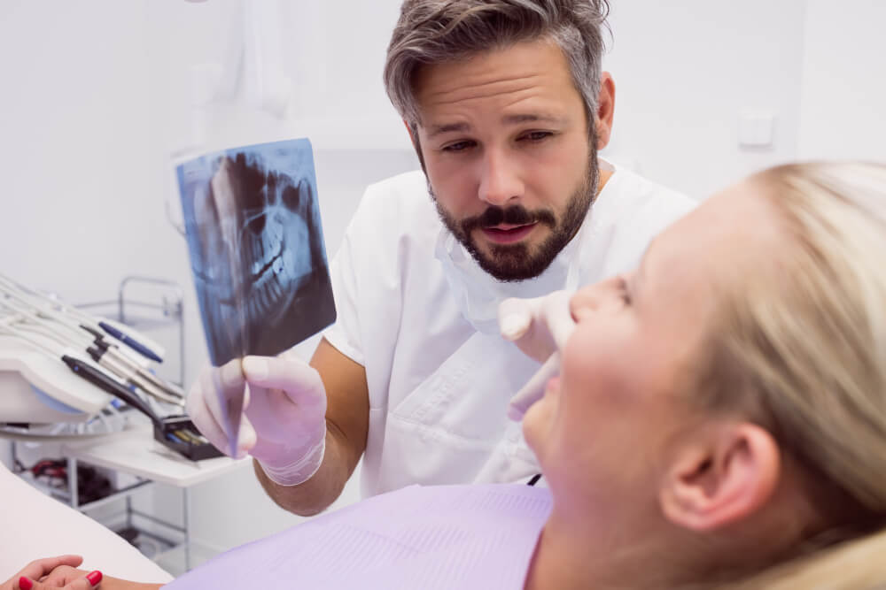 The dentist is advising the removal of a tooth