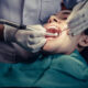 Dentist performing tooth extraction in a dental clinic
