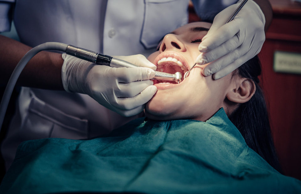 Dentist performing tooth extraction in a dental clinic