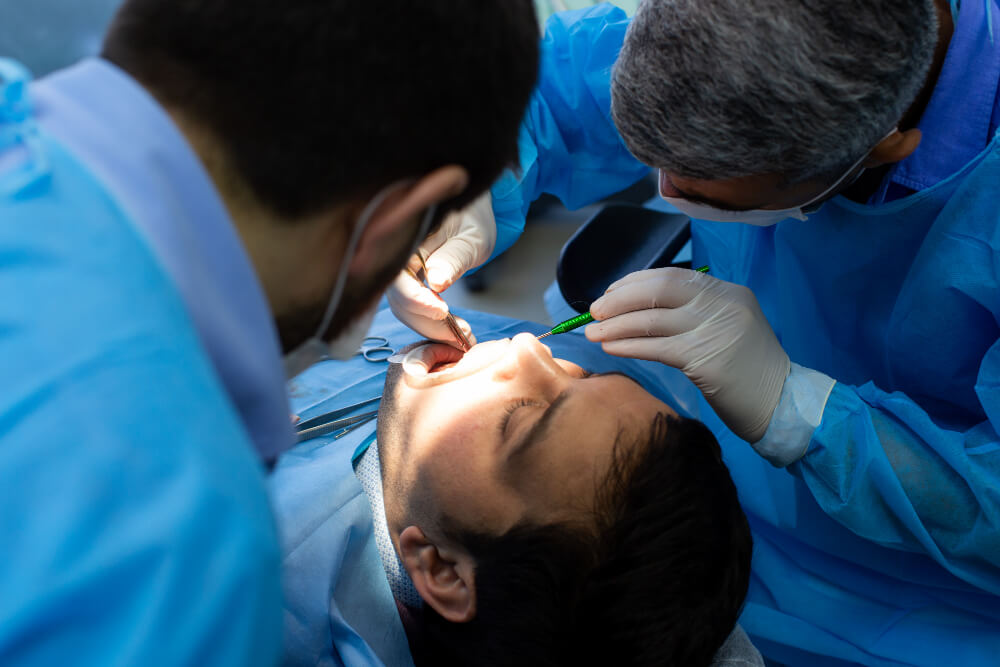 Dentist performing tooth extraction treatment for a patient