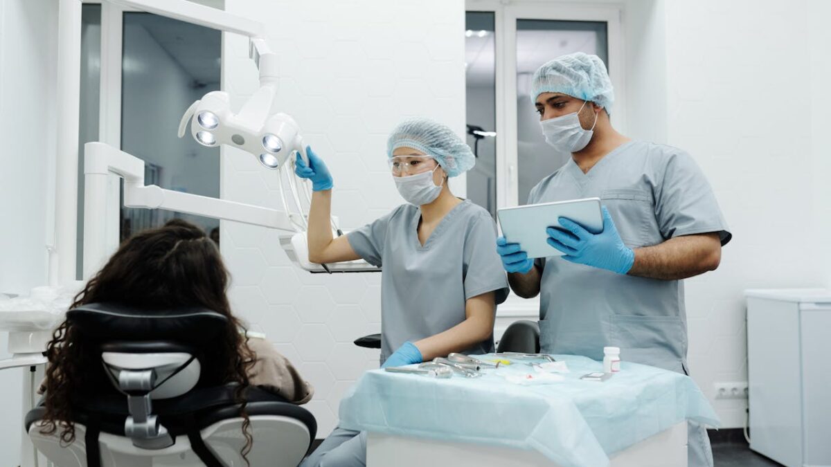 Woman in blue scrubs at dental clinic discussing wisdom teeth removal cost in Sydney