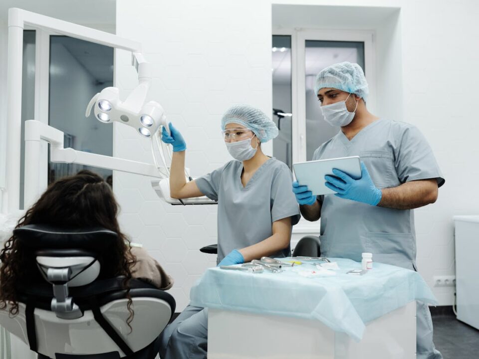 Woman in blue scrubs at dental clinic discussing wisdom teeth removal cost in Sydney