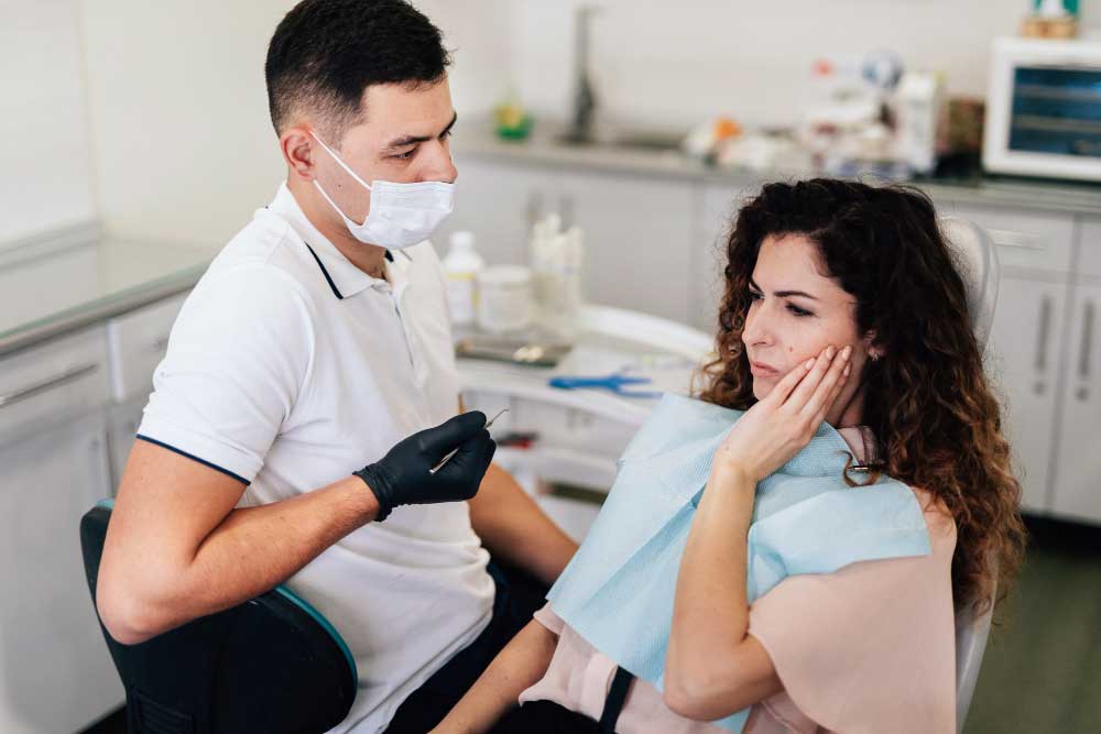 Dental professional consulting patient about wisdom teeth and treatment options.