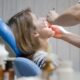 Person undergoing wisdom teeth removal treatment in a dental clinic
