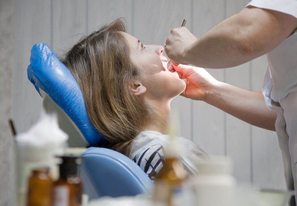 Person undergoing wisdom teeth removal treatment in a dental clinic